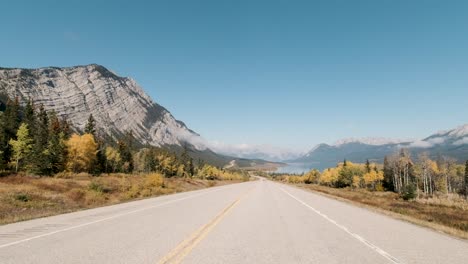 driving along david thompson highway in autumn over looking abraham lake