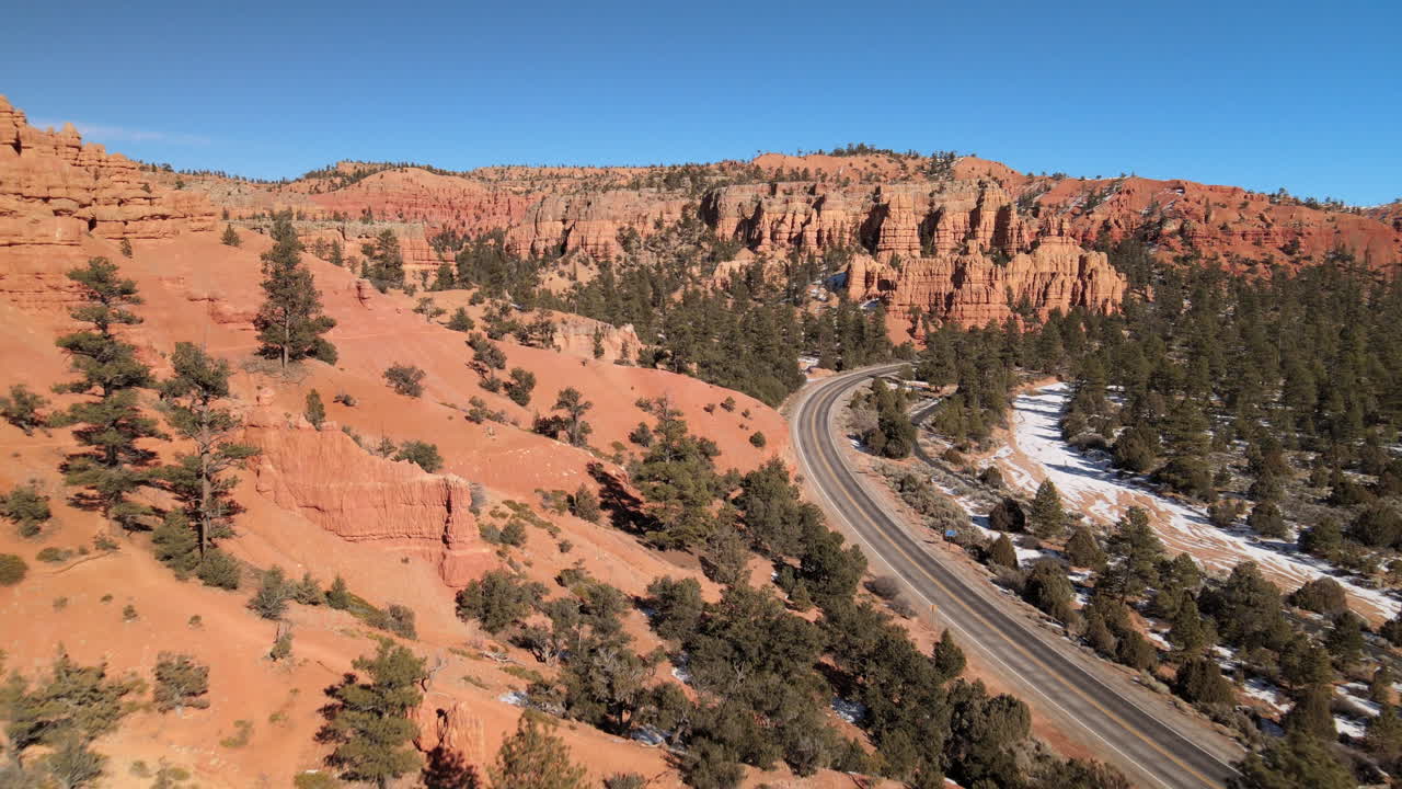 Aerial views of a car driving along Route 12 in the Red Canyon region of the Dixie National Forest near Bryce Canyon National Park, Utah.