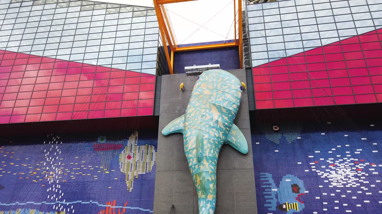 Pan shot across building with fish and ocean design mural