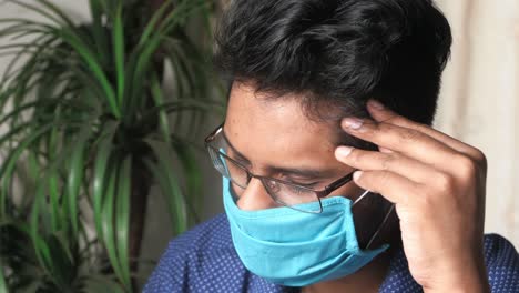 young person with headache and mask