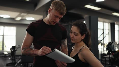 a personal trainer working with a client at the gym