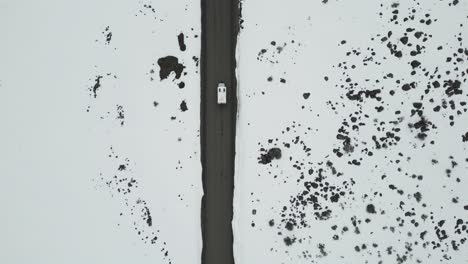 Vanlife--Camper-Van-Driving-Through-The-Road-Amid-The-Snow-covered-Land-In-Idaho,-USA