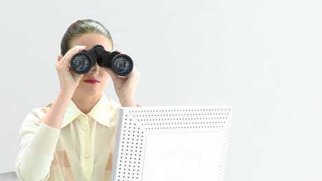 Charismatic-businesswoman-looking-through-binoculars