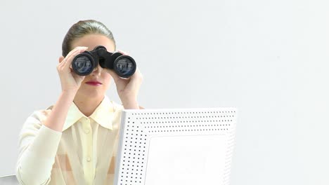 charismatic businesswoman looking through binoculars