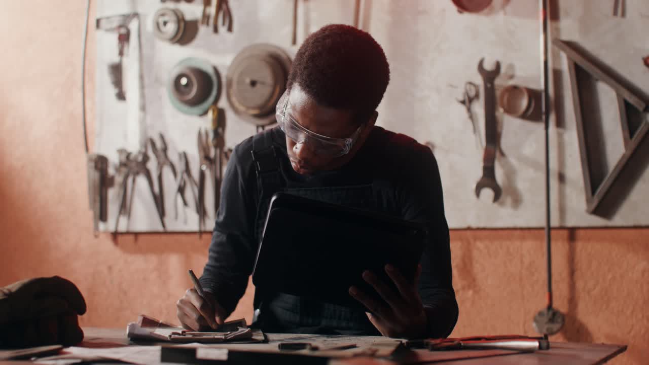 Man working on a tablet in a workshop