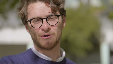 Happy-man-talking-and-looking-at-camera-outdoor