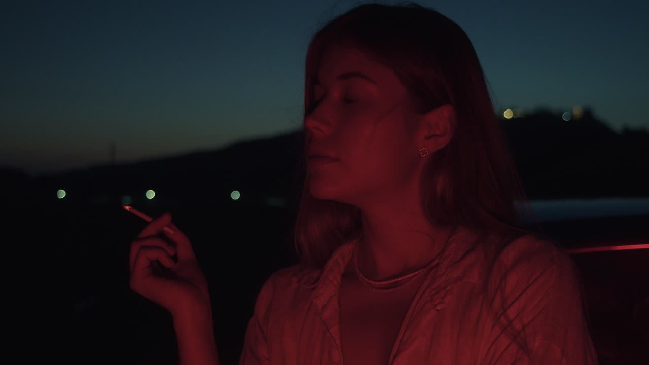 Woman Smoking at Sunset