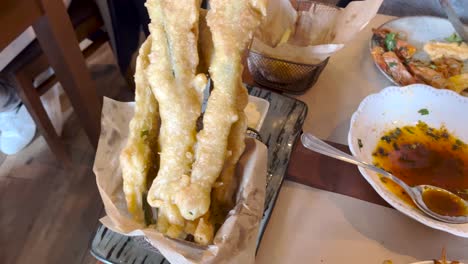 green beans covered in dough or dough and then fried with wine on the side