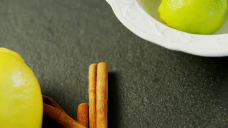 Lemon-and-cinnamon-stick-on-concrete-background-4k