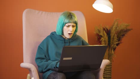 young woman looking at laptop gets frustrated.