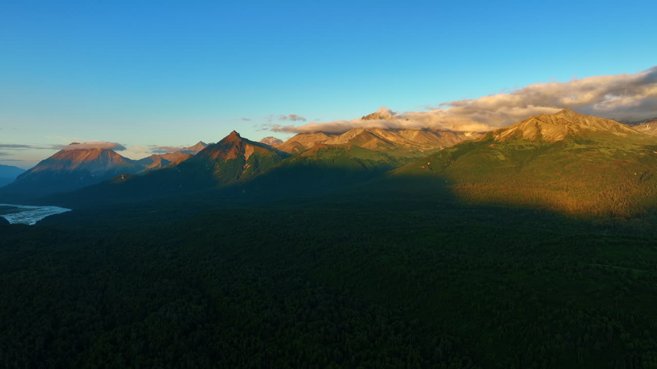 Alaska dusk mountain view. Golden light on majestic peaks offers a stunning view of Alaska's vast wilderness at sunset