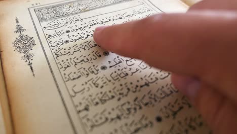 4K footage of a person reading from an old Quran