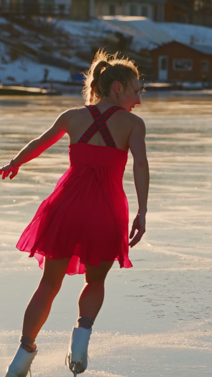An Elegant Ice Skater Dances Gracefully on a Frozen Lake, Capturing the Beauty of Winter Sports in a Stunning Red Dress Under Warm Sunlight, Merging Grace with the Chill of the Ice