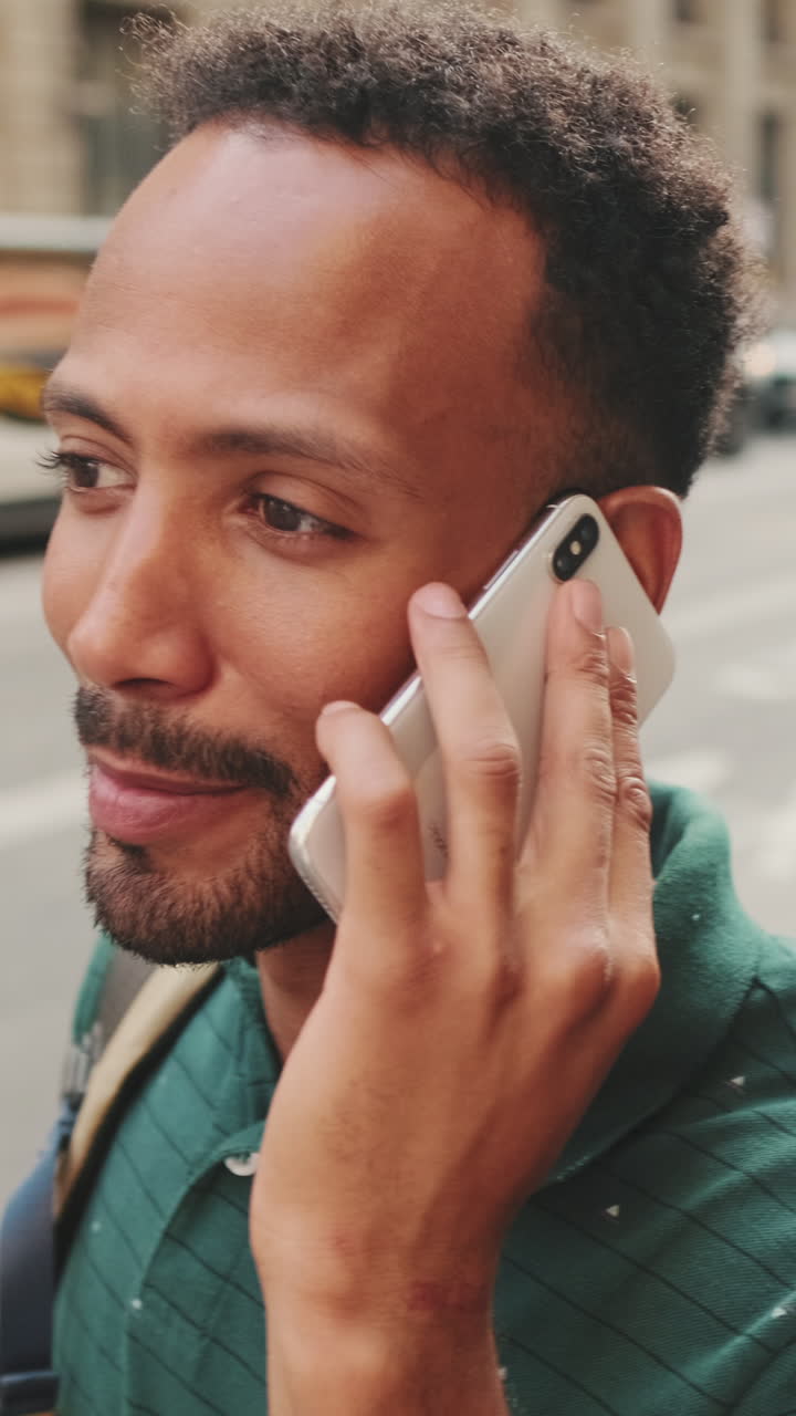 Man talking on phone in city