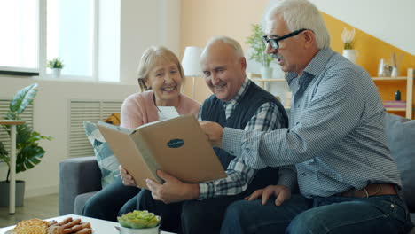 senior friends enjoying a photo album