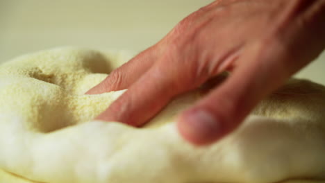 pizzaiolo hand-stretching roman high hydration pizza dough