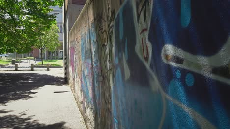 small busy street with a graffiti on the wall in milan italy