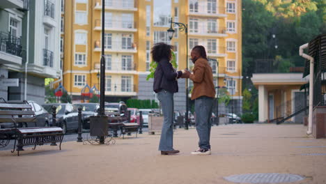 man apologize upset girl standing on city street. relationship problems concept