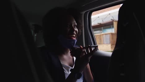 African-american-woman-wearing-face-mask-in-car