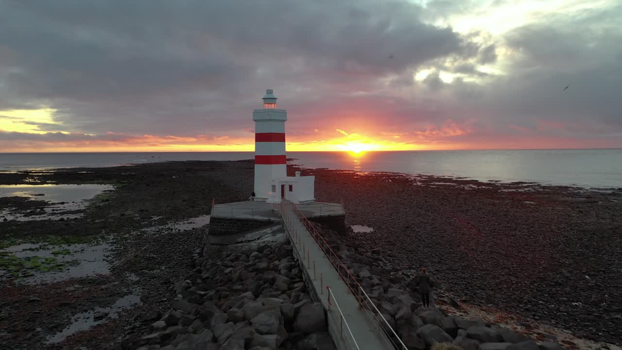 Dramatic sunset at lighthouse Garðskagaviti on point of Reykjanes Peninsula