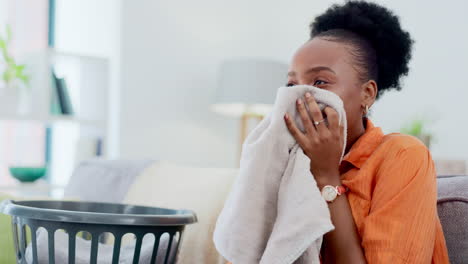 black woman, smelling clean laundry