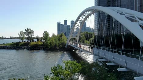 aerial shot flying up above a bridge crossing part of lake ontario near toronto in the summer