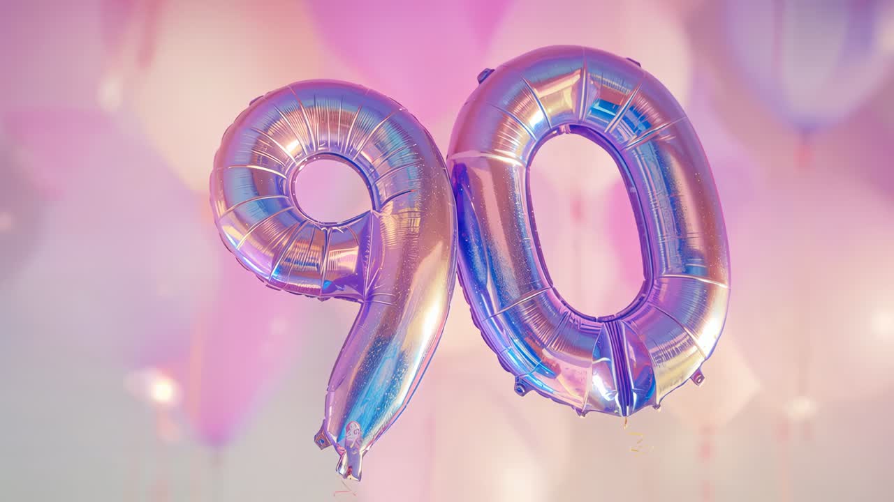 Moving camera showing foil 90 balloons rotating and drifting at pastel backdrop tether for 90th