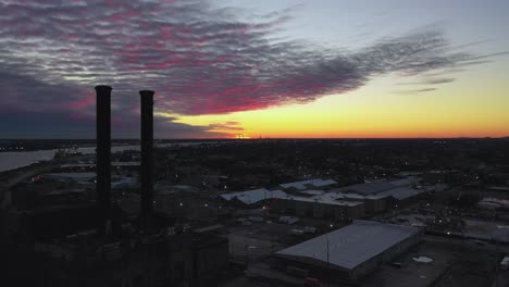 sunset over an abandoned power plant along the mississippi river in new orleans, louisiana