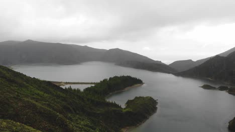 eerie misty landscape in fire lagoon in são miguel island, azores, portugal - fly-over aerial