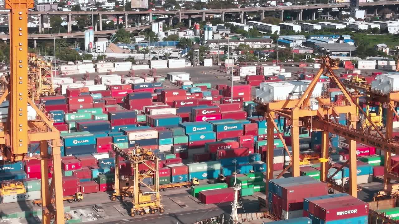 Container yard in Bangkok with cranes and colorful storage boxes