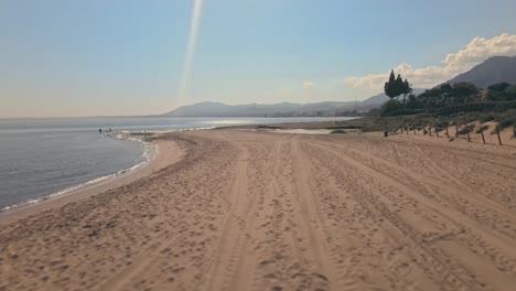 slow forward dolly shot of beach moving into aerial view