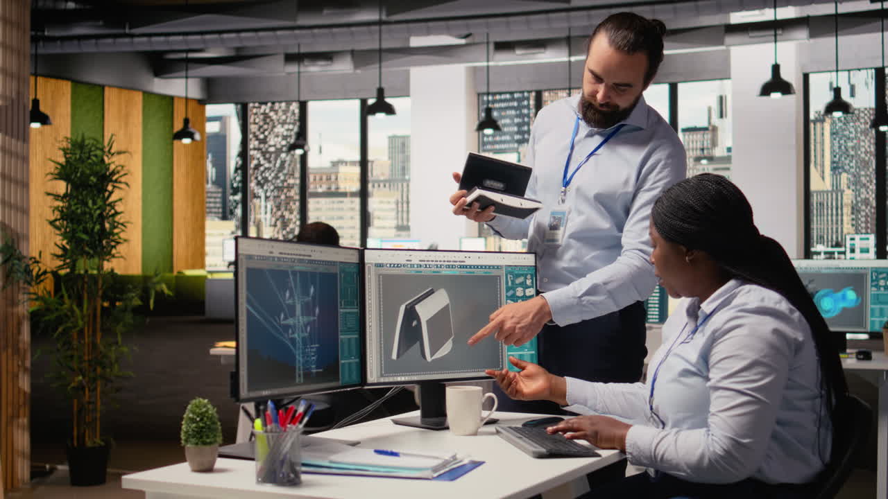 Team Leader Supervising Work Done By Engineer Creating Solar Cell Energy Device