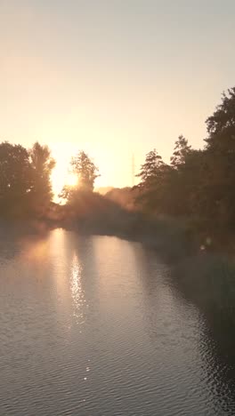 sunrise over a river and countryside