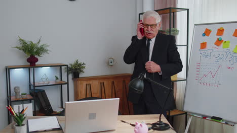 angry senior business man making phone call at office work annoyed boss talking mobile quarrel