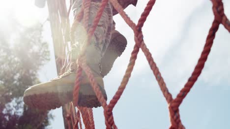 military soldier climbing a net during obstacle course 4k