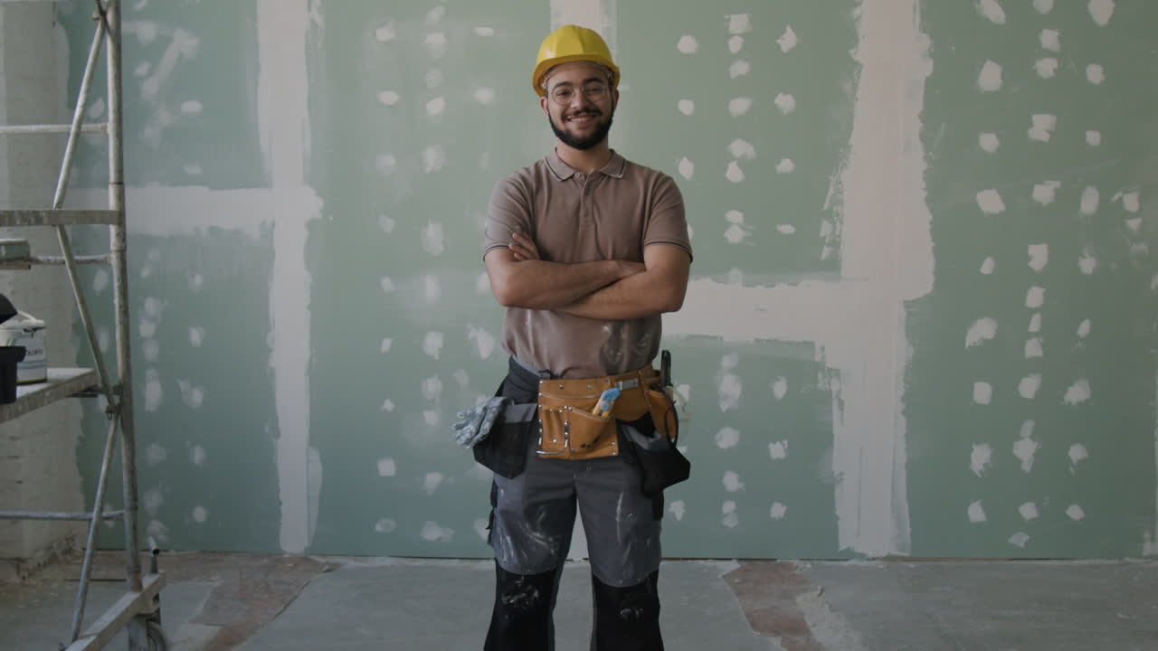 Construction worker in front of drywall
