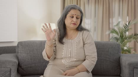 Upset-Indian-old-woman-slapping-her-head