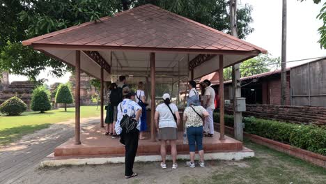 friends gather and chat under a park pavilion