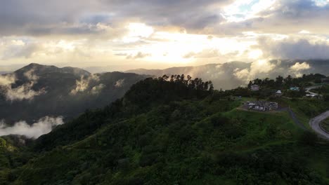 Sunrise-illuminates-the-serene-mountain-landscape-of-Yauco,-Puerto-Rico,-as-seen-from-an-aerial-perspective