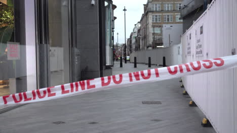 red and white tape that says, “police line, do not cross” marks the cordon on a crime scene during daylight