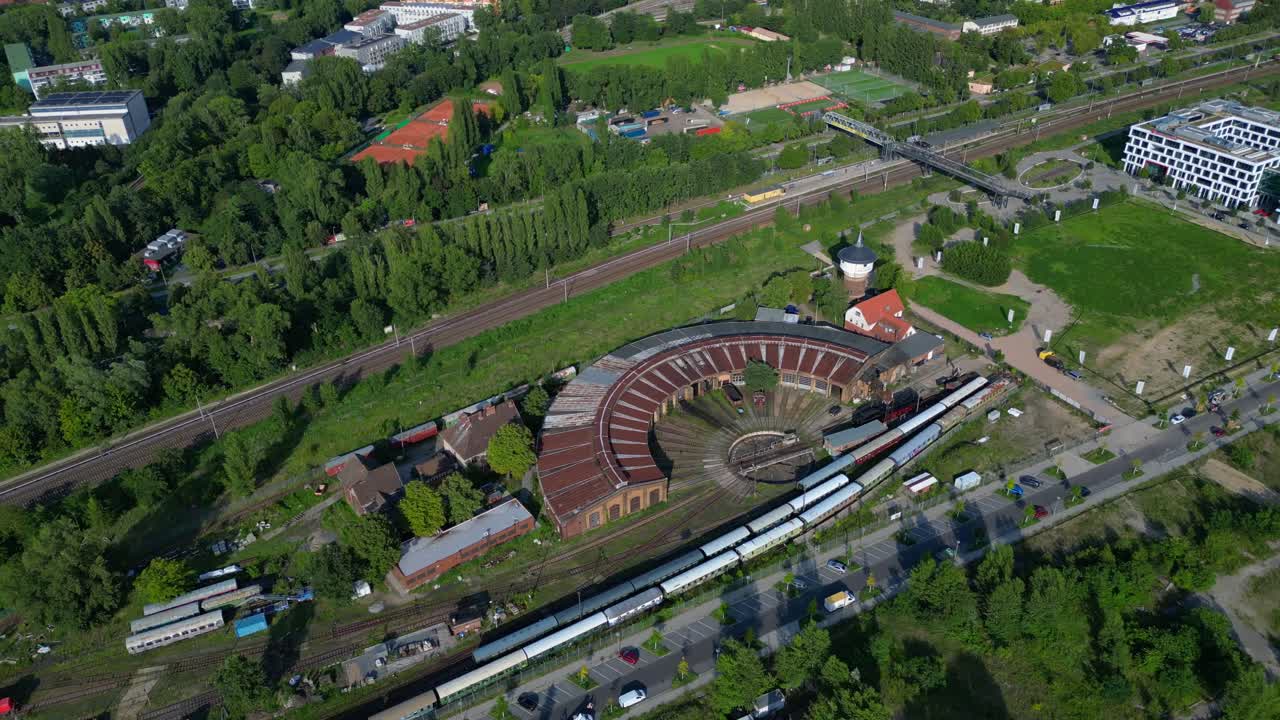 historic steam locomotive shed and trains depot with surrounding urban city Berlin Germany landscape, industrial heritage. Unique aerial view flight drone camera pointing down