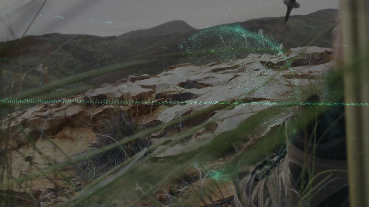 male hiker gripping trekking pole on rocky hillside, displaying green data wave with mapping tech