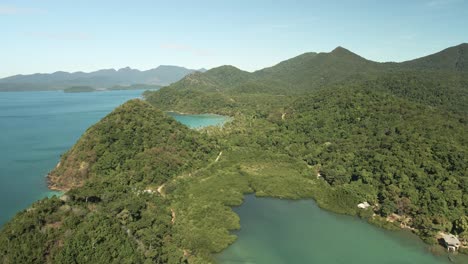 4k-drone-footage,-slow-forward-dolly-of-amazing-island-landscape-with-palms,-lush-forest-covered-hills-and-turquoise-tropical-waters-in-Thailand