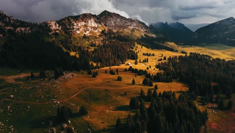 Luz-Muy-Dramática-En-Un-Campo-De-Montaña-Con-Una-Granja-Y-Pastos