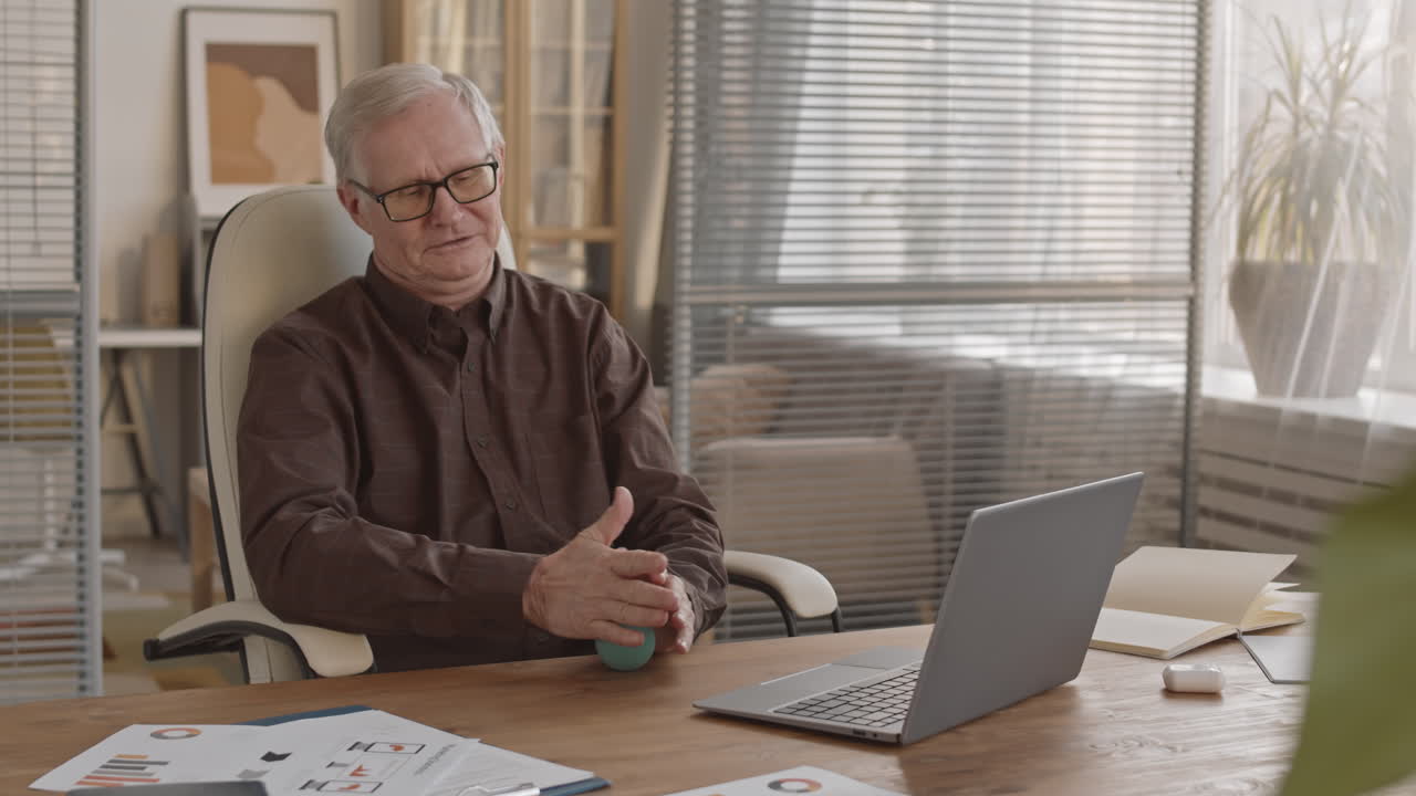 Senior Man Working at Desk