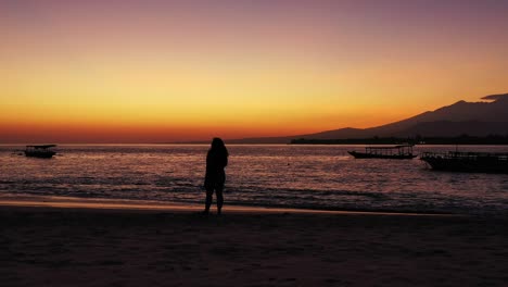 silhouette of a girl with long hair on a bench