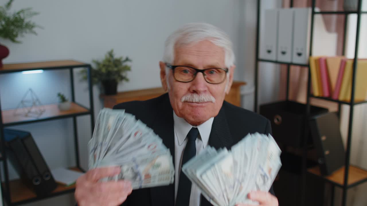 Business man accountant celebrating business success dancing with stack of money dollar cash