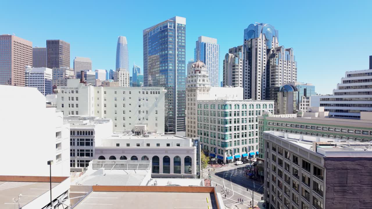 Static elevated city view captures San Francisco skyscrapers framed against a hazy Bay Area afternoon sky