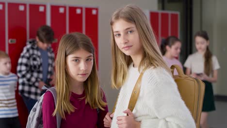 Video-portrait-of-schoolgirls-standing-in-school-corridor