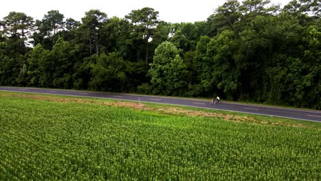 drone following along with a couple as they leisurely bicycle the countryside near the great dismal swamp national wildlife refuge